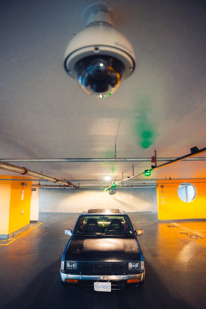our-story A vintage Nissan pick-up truck parked in an underground garage under surveillance.